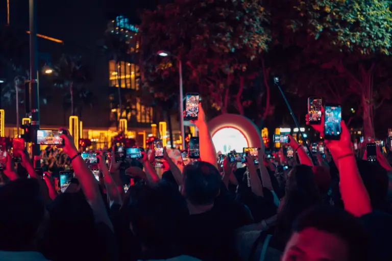 A vibrant crowd in Taguig capturing nightlife with smartphones. Perfect for social media and urban lifestyle themes.